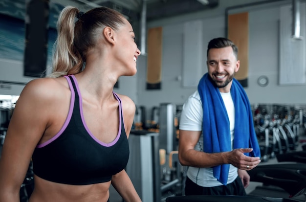 Attractive sports couple talking in the gym