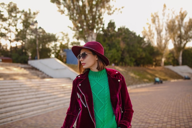 Attractive woman in autumn style trendy outfit walking in street