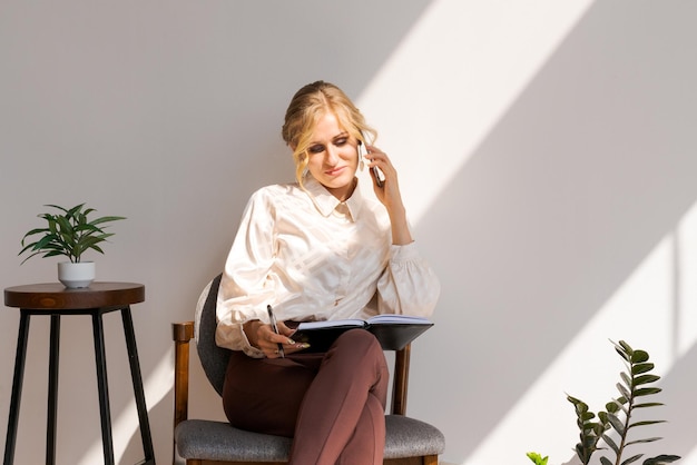 Attractive woman in business clothes with a smartphone in her hands next