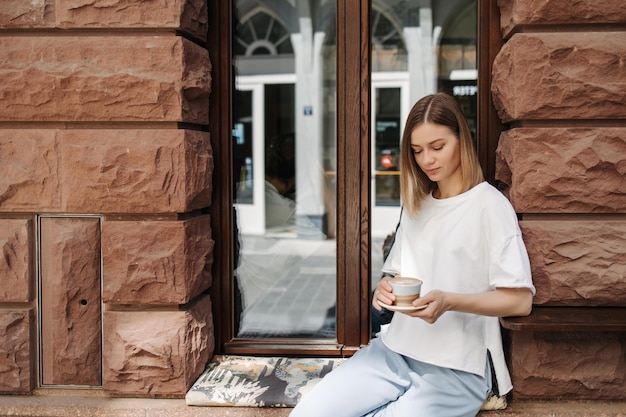 Attractive woman in cafe look at cup coffee