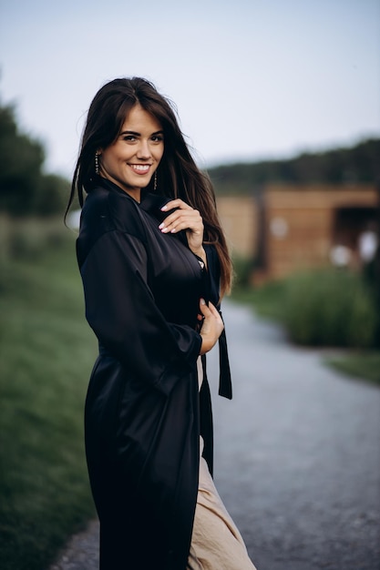 Attractive woman posing in park by the lake