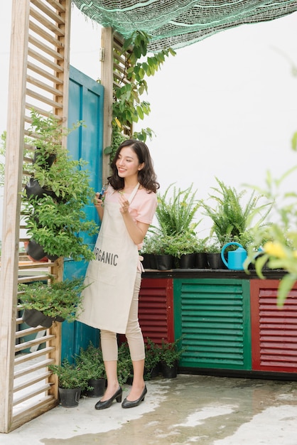 Attractive Woman pruning of trees with secateurs in the garden