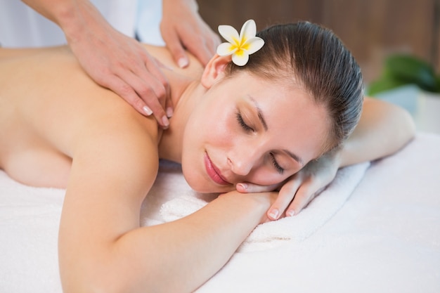 Attractive woman receiving back massage at spa center