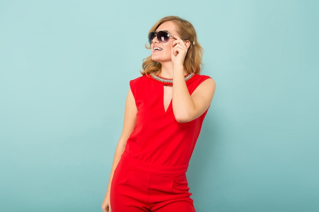 Attractive woman in red overalls and sunglasses