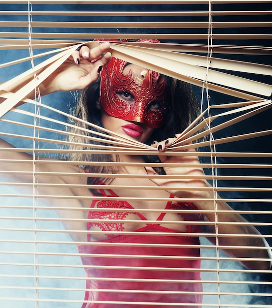 Attractive woman in red with mask