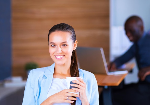 Attractive woman sitting at desk in office