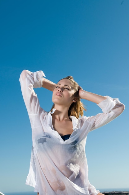 attractive woman in the sun in a seaside area in good weather