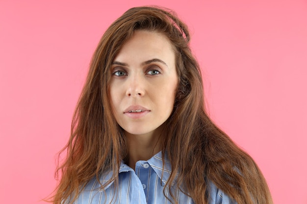 Attractive woman in t-shirt on pink background