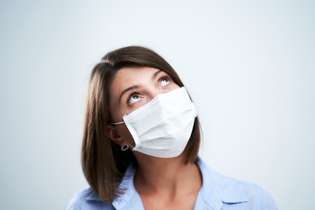 attractive woman wearing protective mask isolated over white background