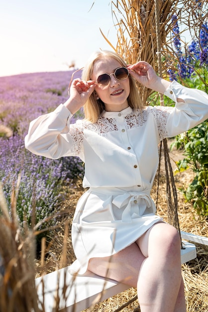 Attractive woman with fashion makeup posing on lavender field