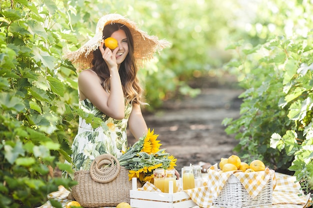 Attractive woman with lemons. Beautiful lady outdoors.