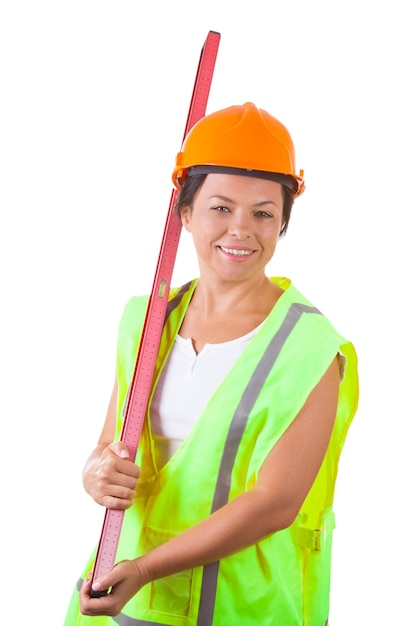 Attractive Woman Worker in Safety Jacket and Yellow Helmet with Bubble Level Gauge on a white background