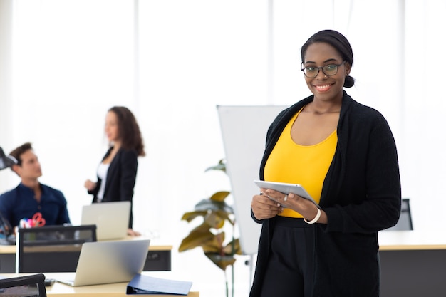 Attractive young african american business woman portrait standing. Business corporate leadership concept