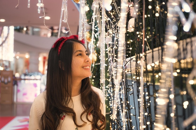 Attractive young asian woman enjoying in light bulb tunnel on festival