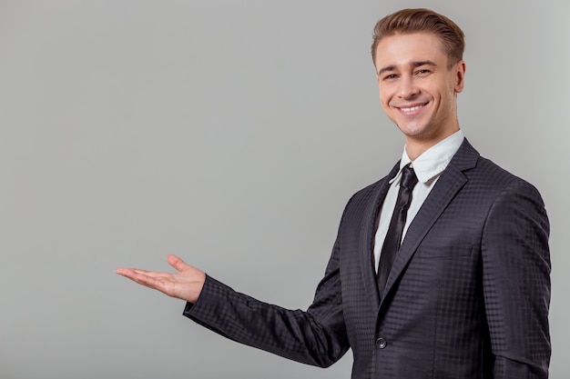 Attractive young blond businessman in classical suit.