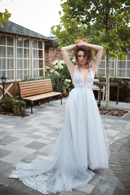 Attractive young bride posing outside