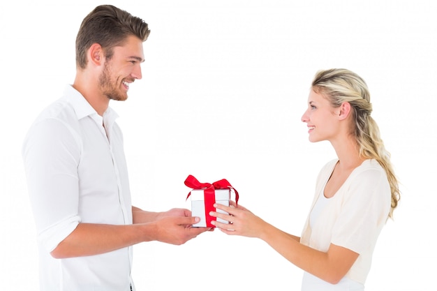 Attractive young couple holding a gift