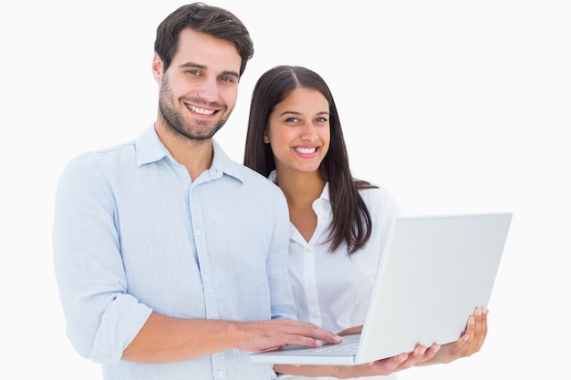 Attractive young couple holding their laptop