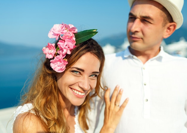 Attractive young couple walking alongside the marina in summer sunshine wedding concept