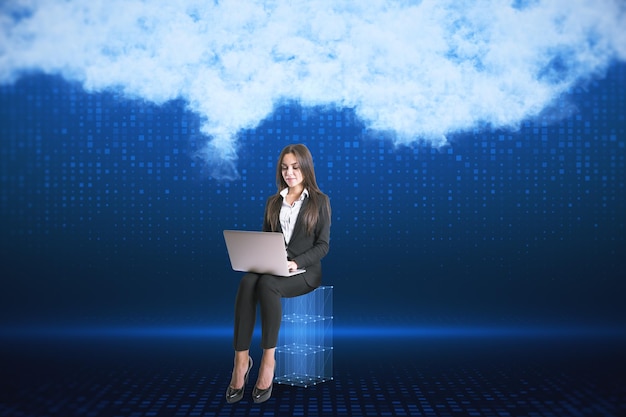 Attractive young european businesswoman with laptop on blurry digital blue background with abstract cloud Cloud computing big data and digital transformation concept