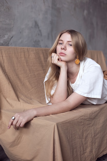 Attractive young girl lying on a bench