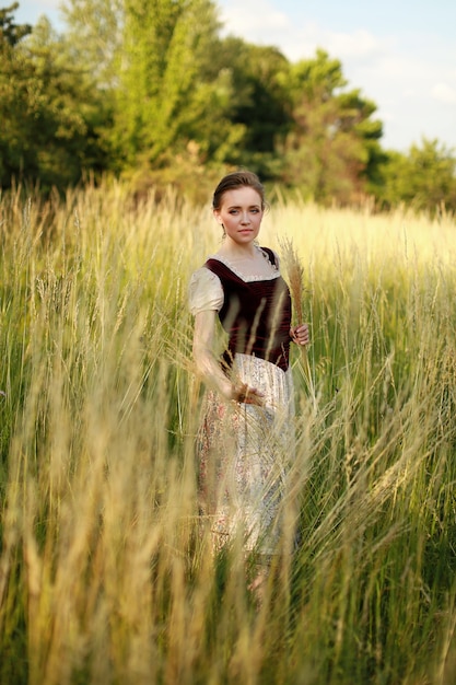 Attractive young lady in the field . One model in a sunny field.