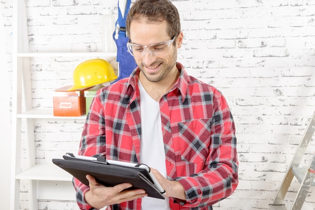 attractive young man using the tablet for DIY