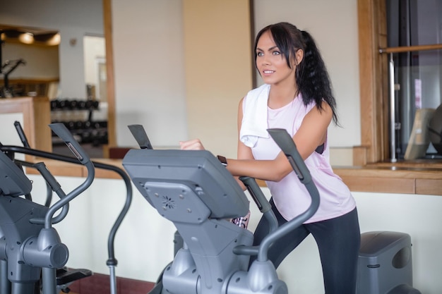 Attractive young sports woman is working out in gym