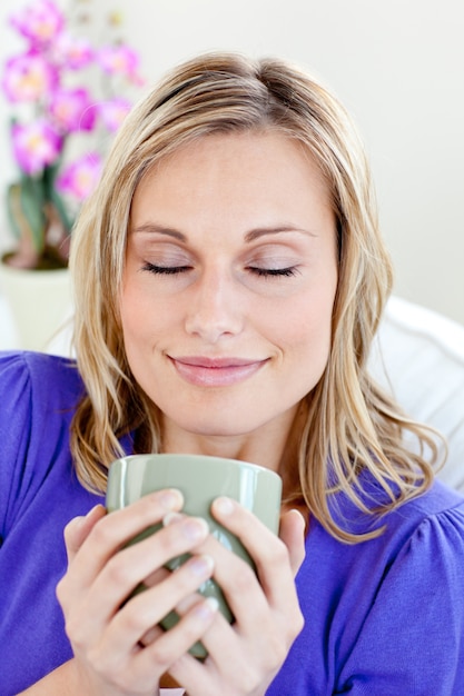 Attractive young woman enjoying her coffee