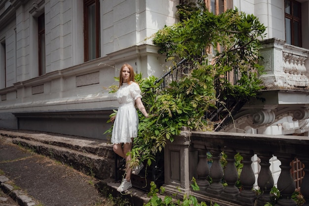 Attractive young woman enjoying her time outside in park Beautiful palace juicy greens after a rain in the spring