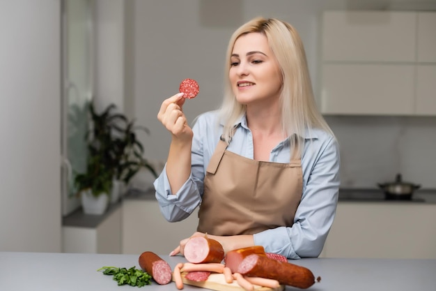 Attractive Young Woman Holding a Sausage