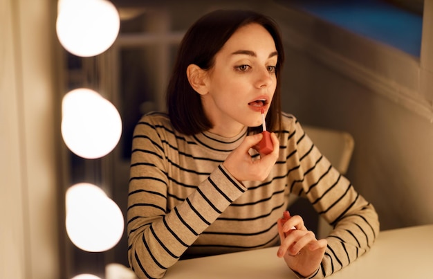 Photo attractive young woman testing brand new beauty product lipstick