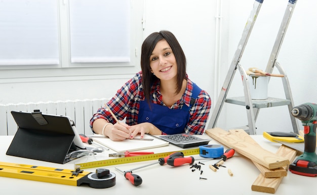 Attractive young woman using the tablet for DIY