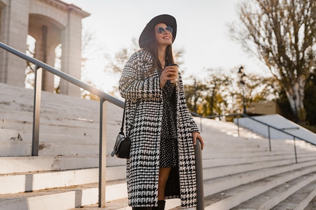 Attractive young woman walking in autumn wearing coat