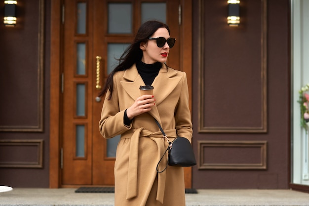 Attractive young woman wearing beige coat