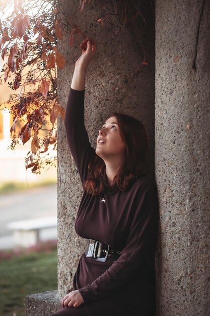 An attractive young woman with a sad pensive expression in a park on a sunny day Shallow depth of field female creative portrait