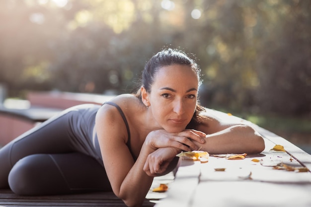 An attractive young woman with a sad pensive expression in a park on a sunny day Shallow depth of field female creative portrait