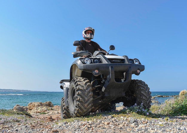 ATV offroad on mountain and sky background