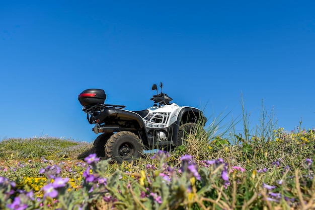 ATV offroad on mountain and sky background