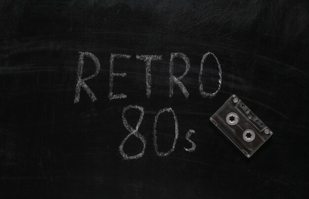 Audio cassette and Word retro 80s chalk hand drawn on blackboard