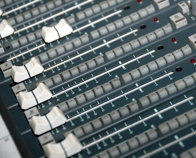 Audio mixing console in a recording studio. Faders and knobs of a sound mixer.