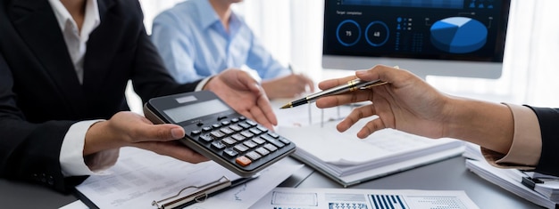 Auditor and accountant team working in office analyze financial data and accounting record with calculator Accounting company provide finance and taxation planning for profitable cash flow Insight