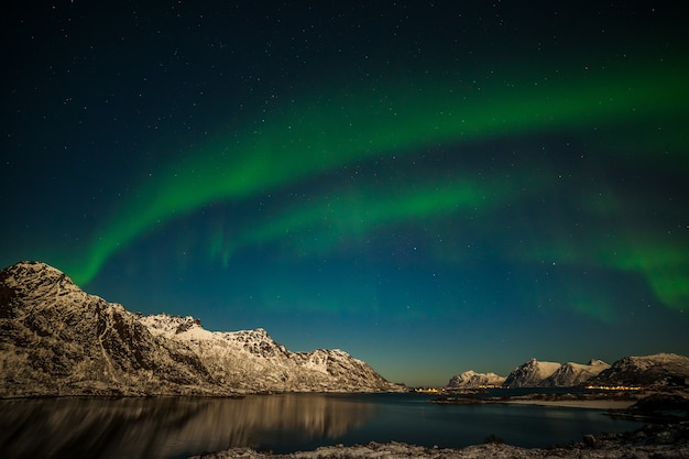 Aurora borealis on the Lofoten islands, Norway. Green northern lights above mountains