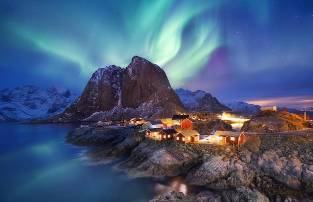 Aurora borealis on the Lofoten islands Norway Green northern lights above ocean Night sky with polar lights Night winter landscape with aurora and reflection on the water surface Norwayimage