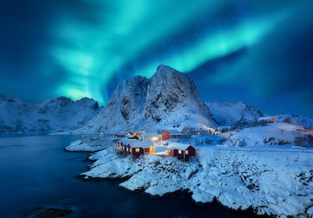 Aurora Borealis Lofoten islands Norway Winter landscape with northern lights View on the houses in the Hamnoy village Lofoten Islands Norway