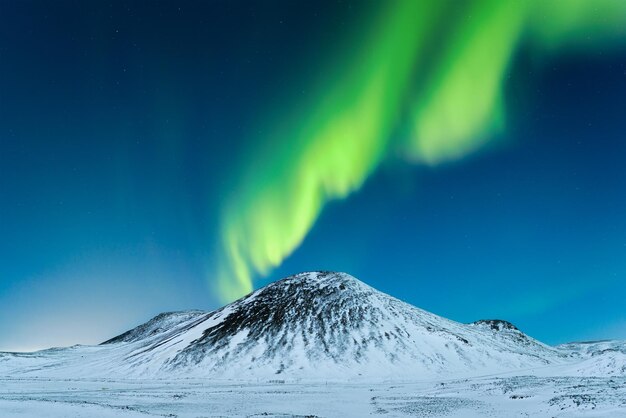 Aurora Borealis Northern Lights over the mountains A winter night landscape with bright lights in the sky Landscape in the north in winter time A popular place to travel