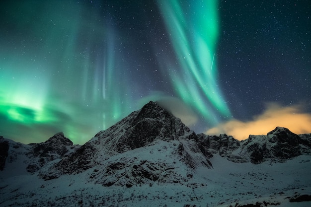 Aurora borealis, Northern lights with starry over snow mountain peak on winter at Lofoten islands, Nordland, Norway