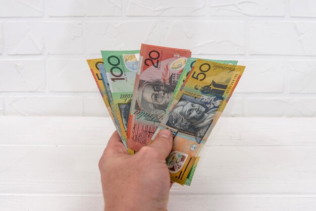 Australian dollar banknotes in hand giving for exchange