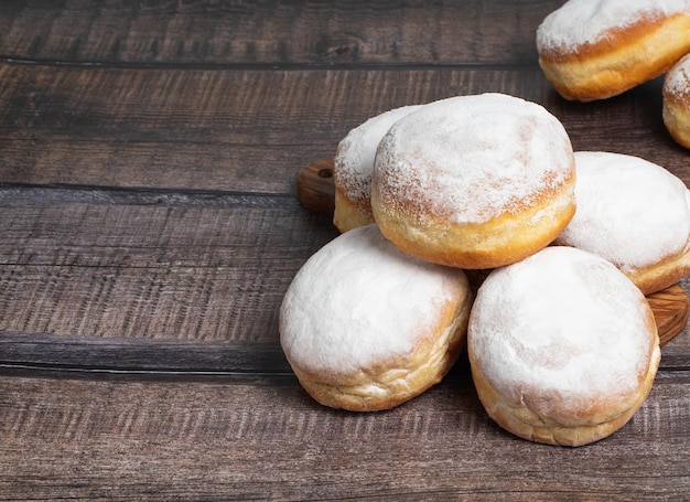 Austrian and german donuts or krapfen Faschingskrapfen Berliner with cream On wooden background Selective focus