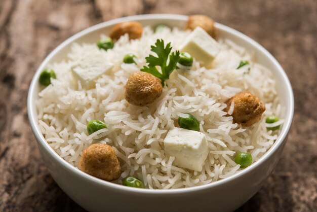 Authentic paneer or soya bean or green peas pulav or vegetables rice or veg biryani with paneer cubes and soya chunk, selective focus